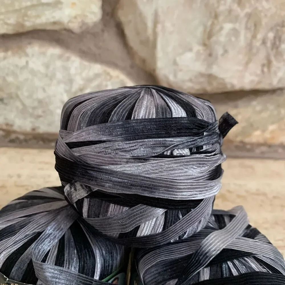 Lion brand incredible ribbon yarn in accent on black